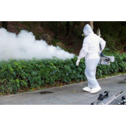 Operator in protective gear fogging street park,